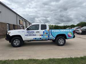 Partial wrap for Pinch-A-Penny Pool Patio Spa on a Toyota Tacoma by 1st Class Graphics in Mansfield, TX