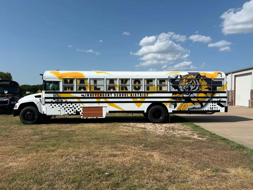 Partial wrap for Malakoff Independent School District on a school bus by 1st Class Graphics in Mansfield, TX