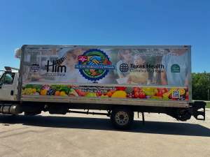Partial wrap for Him Food Bank on a box truck by 1st Class Graphics in Mansfield, TX